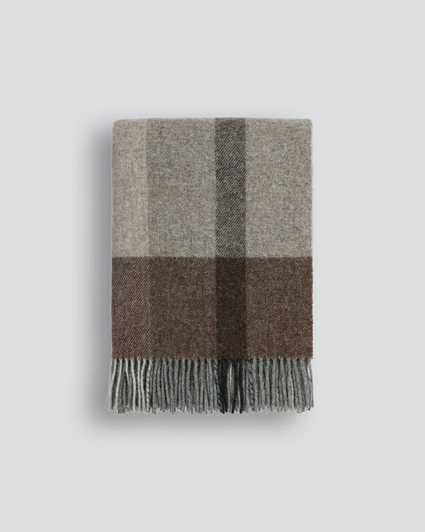 Brunswick Throw Featuring an offset plaid design, a modern take on country style is celebrated in this luxurious, pure wool throw. Crafted from New Zealand grown wool, the timeless design and warm bark tones creates a reassuring sense of warmth and comfor