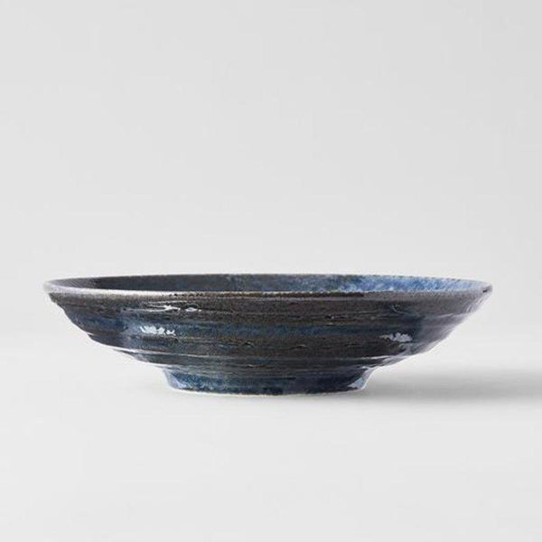 Save on Midnight Blue Open Bowl Made in Japan at BEON. 22cm diameter x 5cm height Open bowl in Midnight Blue design Featuring a dark indigo gloss with subtle brown undertones. The glaze runs over a pattern of concentric circles. It works in perfect harmony with the rustic shapes made by the kiln. This open bowl is a great shape for sharing dishes. Use for pasta, curries, risottos or salads. Handcrafted in Japan.Microwave and dishwasher safe.