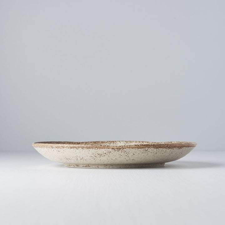 Save on Sand Fade Uneven Plate Made in Japan at BEON. 24.5cm diameter x 3cm height Uneven plate in Sand Fade Design The Sand Fade Glaze features a warm, sandy tone with touches of hazel brown. Each piece has a unique speckled pattern determined by its position in the kiln during the firing process. The perfect size plate to use as an everyday dinner plate or to use on special occasions. Handcrafted in JapanMicrowave and dishwasher safe