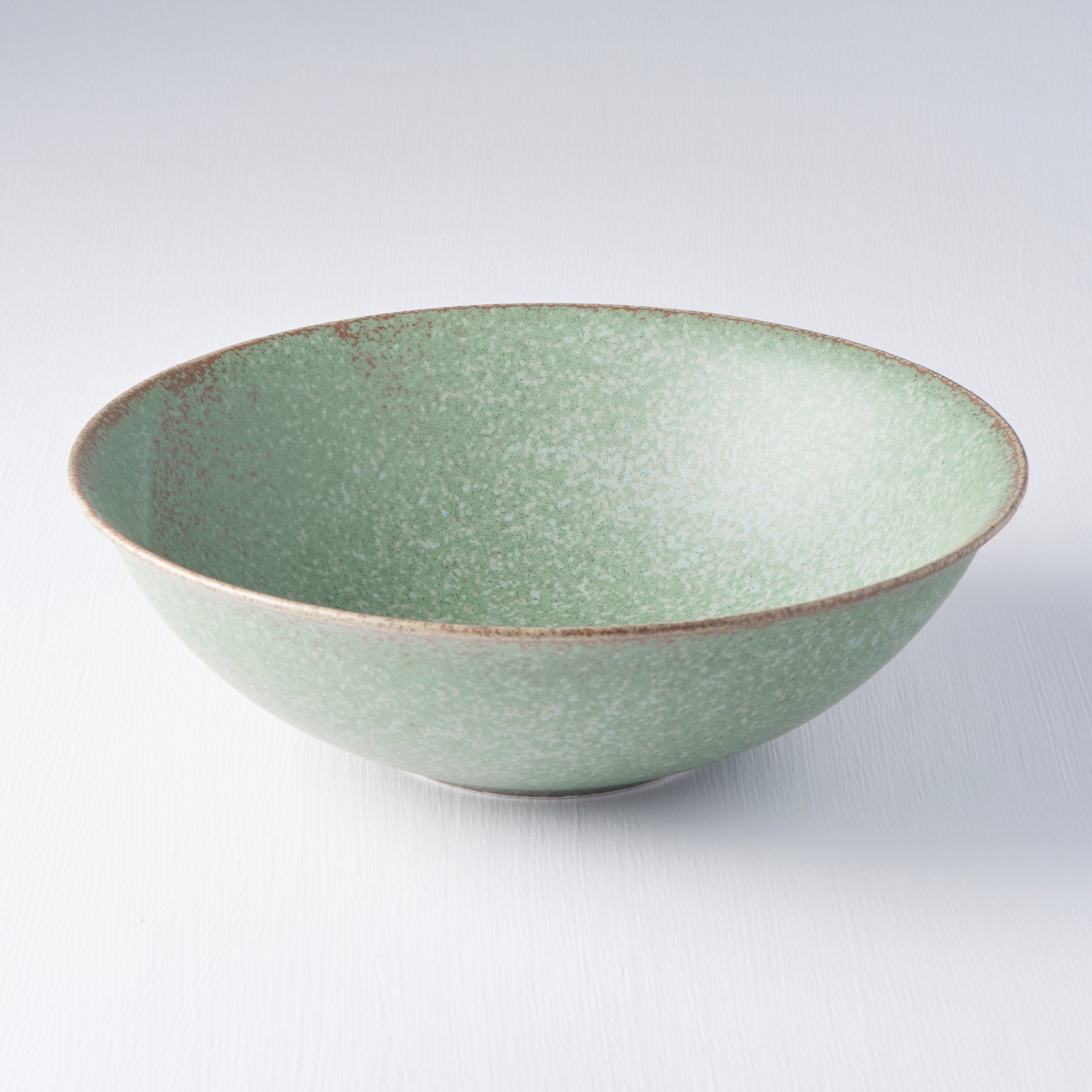 Save on Green Fade Open Bowl Made in Japan at BEON. 22cm diameter x 6cm height Open bowl in Green Fade design. The Green Fade glaze features a lush, forest green tone with button-flower blue highlights and an edge of light brown. Each piece has a unique dappled pattern determined by its position in the kiln during the firing process. The beautifully shaped bowl can be used for noodles, soups, salads, pasta and risottos Handcrafted in Japan. Microwave and dishwasher safe.