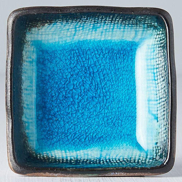 Save on Sky Blue Square Sauce Dish Made in Japan at BEON. 7cm width x 2.5cm height. Square Sauce Dish in Sky Blue design. The sky blue glaze is fired at a low temperature to create a unique 'crackle' effect over a deep and vibrant blue background. A perfect dish for sauces to accompany dumplings, spring rolls and sausage rolls. Handcrafted in Japan CRACKLE GLAZES - The spectacular glazes that look like cracked glass on the surface require slightly more care than our regular products. Don’t use in a microwav