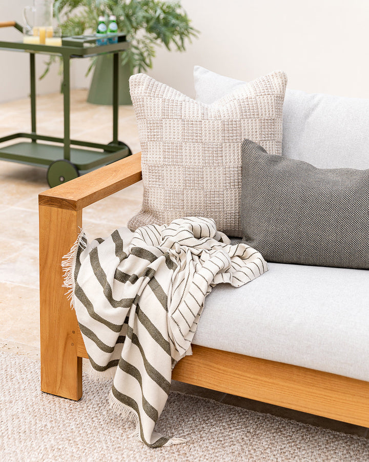 Carter Cushion Elevate your outdoors with the soft nougat and almond tones of our Carter cushion. Handwoven in a textural check design, this versatile piece transitions seamlessly to indoor settings. This piece is crafted using PET yarn, a resilient fibre