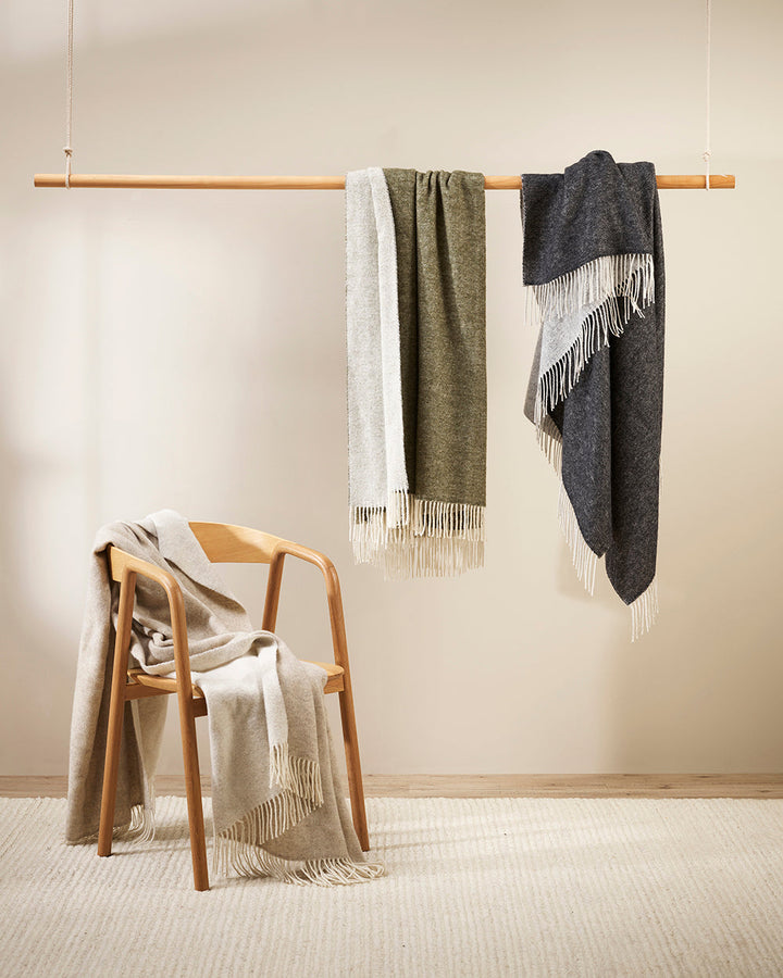 Casa Throw Beautifully soft and lightweight, the Casa adds an unparallel sense of timeless luxury to a space. Woven in a two-tone, reversible design, the merino composition feels inviting and cocoon-like, while the warm charcoal tone adds a gentle contras