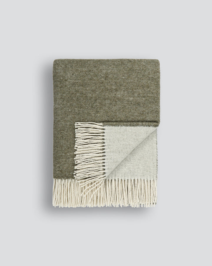 Casa Throw Beautifully soft and lightweight, the Casa adds an unparallel sense of timeless luxury to a space. Woven in a two-tone, reversible design, the merino composition feels inviting and cocoon-like, while the warm charcoal tone adds a gentle contras