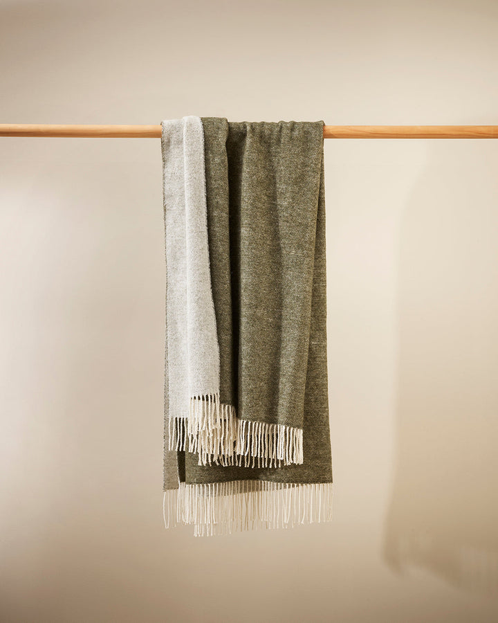 Casa Throw Beautifully soft and lightweight, the Casa adds an unparallel sense of timeless luxury to a space. Woven in a two-tone, reversible design, the merino composition feels inviting and cocoon-like, while the warm charcoal tone adds a gentle contras