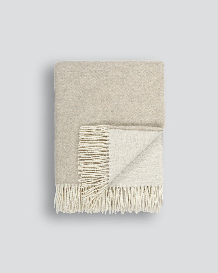 Casa Throw Beautifully soft and lightweight, the Casa adds an unparallel sense of timeless luxury to a space. Woven in a two-tone, reversible design, the merino composition feels inviting and cocoon-like, while the warm charcoal tone adds a gentle contras
