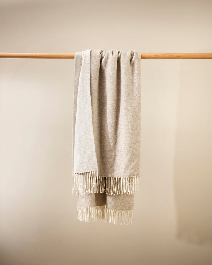 Casa Throw Beautifully soft and lightweight, the Casa adds an unparallel sense of timeless luxury to a space. Woven in a two-tone, reversible design, the merino composition feels inviting and cocoon-like, while the warm charcoal tone adds a gentle contras
