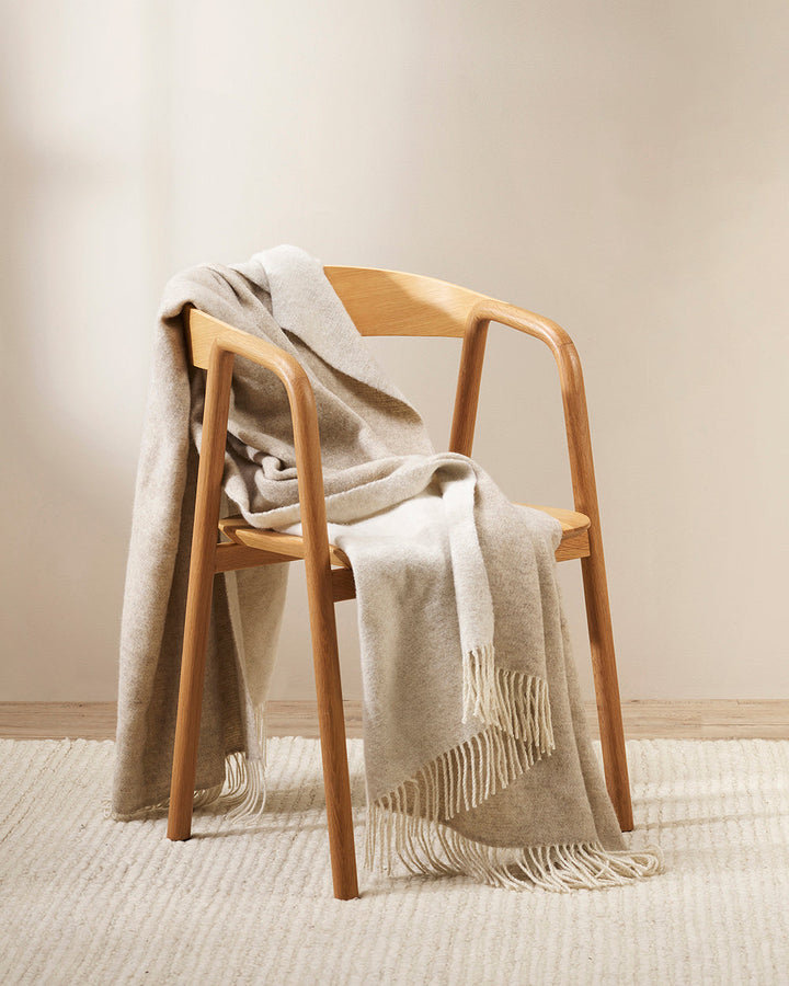 Casa Throw Beautifully soft and lightweight, the Casa adds an unparallel sense of timeless luxury to a space. Woven in a two-tone, reversible design, the merino composition feels inviting and cocoon-like, while the warm charcoal tone adds a gentle contras