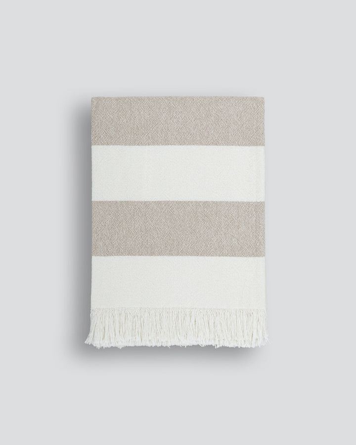 Cheltenham Throw Add a touch of summer to your home with this Cheltenham Throw. Made of 100% cotton, it features a wide stripe design in a delicate powdery blue color. The cross-woven pattern with white detailing and frayed edges brings to mind carefree p