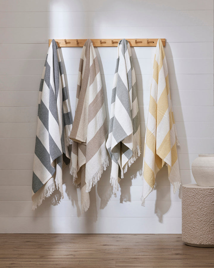 Cheltenham Throw Add a touch of summer to your home with this Cheltenham Throw. Made of 100% cotton, it features a wide stripe design in a delicate powdery blue color. The cross-woven pattern with white detailing and frayed edges brings to mind carefree p
