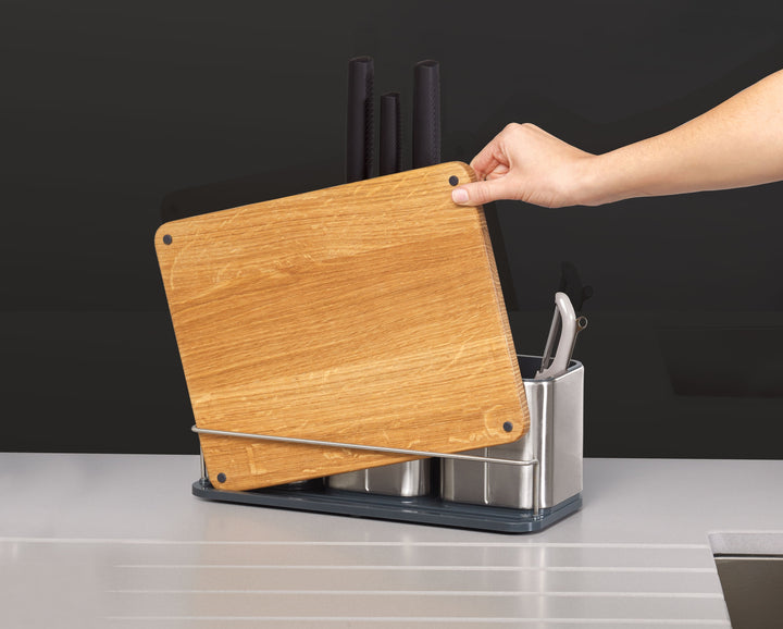 Buy online & save CounterStore™ 100 Worktop Organiser The compact design of this stylish worktop organiser means you can store knives, gadgets and utensils in one convenient place that also looks great in your kitchen. Organised storage for utensils, gadgets and knives Easy-clean stainless-steel body with fingerprint-proof coating Non-slip oak chopping board included Non-scratch knife slots grip blades securely Suitable for knife blades up to 20cm (8 inches) Specifications Care & use: Chopping board - wash