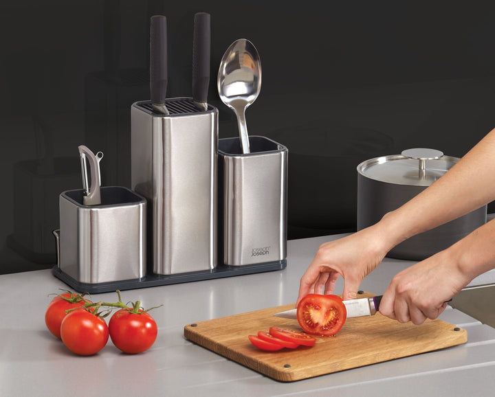 Buy online & save CounterStore™ 100 Worktop Organiser The compact design of this stylish worktop organiser means you can store knives, gadgets and utensils in one convenient place that also looks great in your kitchen. Organised storage for utensils, gadgets and knives Easy-clean stainless-steel body with fingerprint-proof coating Non-slip oak chopping board included Non-scratch knife slots grip blades securely Suitable for knife blades up to 20cm (8 inches) Specifications Care & use: Chopping board - wash