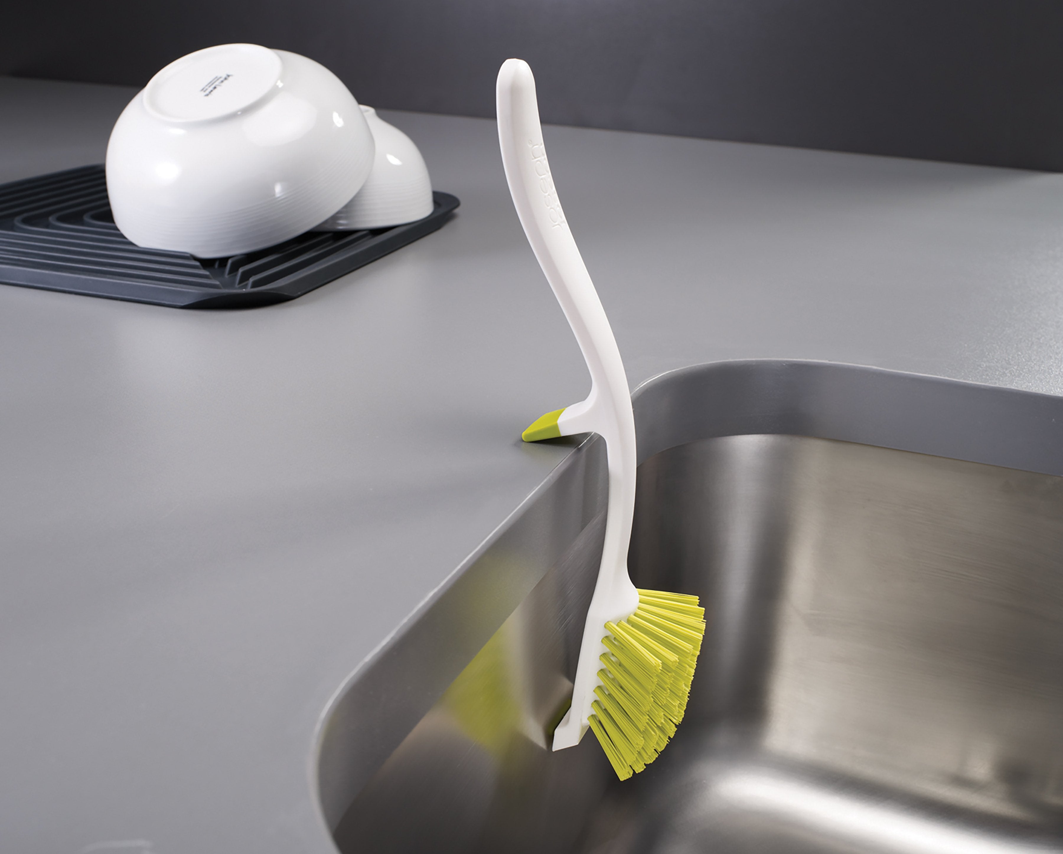 BEON.COM.AU  This clever washing-up brush is designed to rest securely on the side of your sink, letting all the soapy suds simply drain away.  Washing-up brush with integrated sink rest Non-scratch, curved brush head with integrated pan scraper Excess water drains directly into sink Non-slip resting point g... Joseph Joseph at BEON.COM.AU