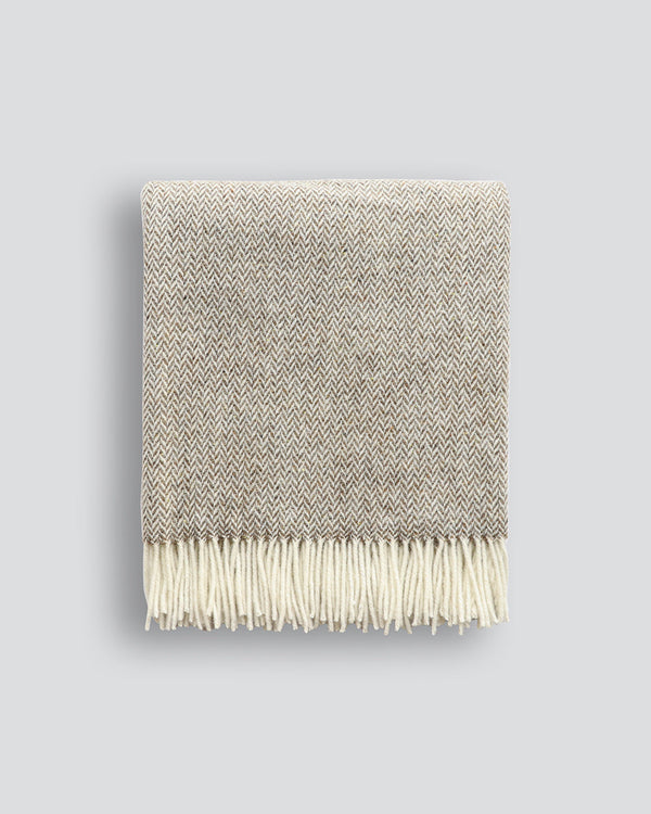 Featherston Throw Featuring a subtle herringbone weave, classic design is celebrated in this luxurious, pure wool throw. Locally crafted from wool grown in the Hawkeâ€™s Bay, the timeless pattern and natural bracken tone creates a reassuring sense of warm