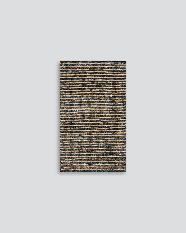 Lima Entrance Mat Invite simple, raw texture into your space with the beauty of natural fibres. Handwoven from a stunning blend of jute and wool, the Lima features a stripe pattern in a striking charcoal colourway. An excellent all-rounder for a wide rang