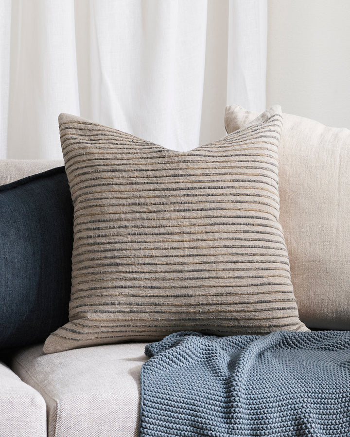 Luigi Cushion Soothe your senses with this space-dyed cushion in classic blue, white and natural linen hues. Handcrafted by artisan makers, this understated, textural design invites us to touch, rest and slow down. Coordinate with natural and cloudburst c