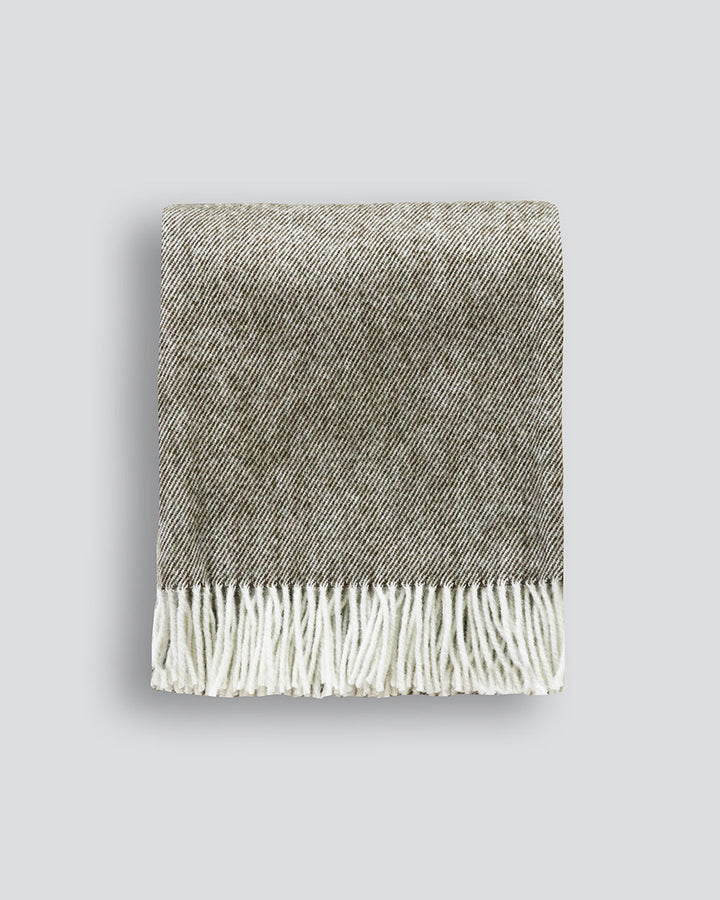 Martinborough Throw Featuring a sophisticated twill weave, classic design is celebrated in this luxurious, pure wool throw. Locally crafted from wool grown in the Hawkeâ€™s Bay, the timeless design and natural olive tone creates a reassuring sense of warm