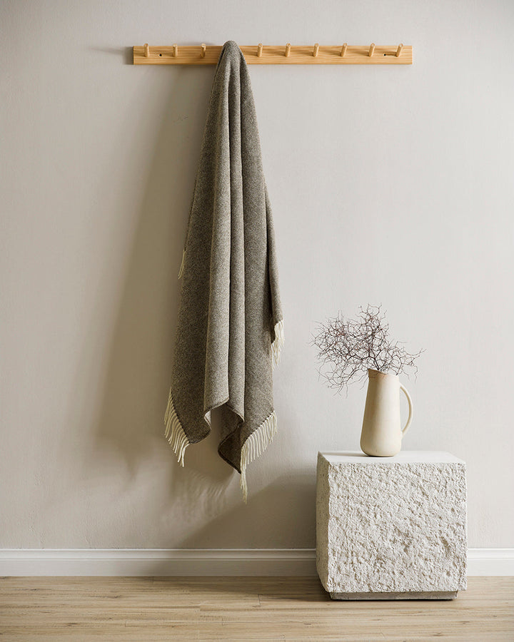 Martinborough Throw Featuring a sophisticated twill weave, classic design is celebrated in this luxurious, pure wool throw. Locally crafted from wool grown in the Hawkeâ€™s Bay, the timeless design and natural olive tone creates a reassuring sense of warm