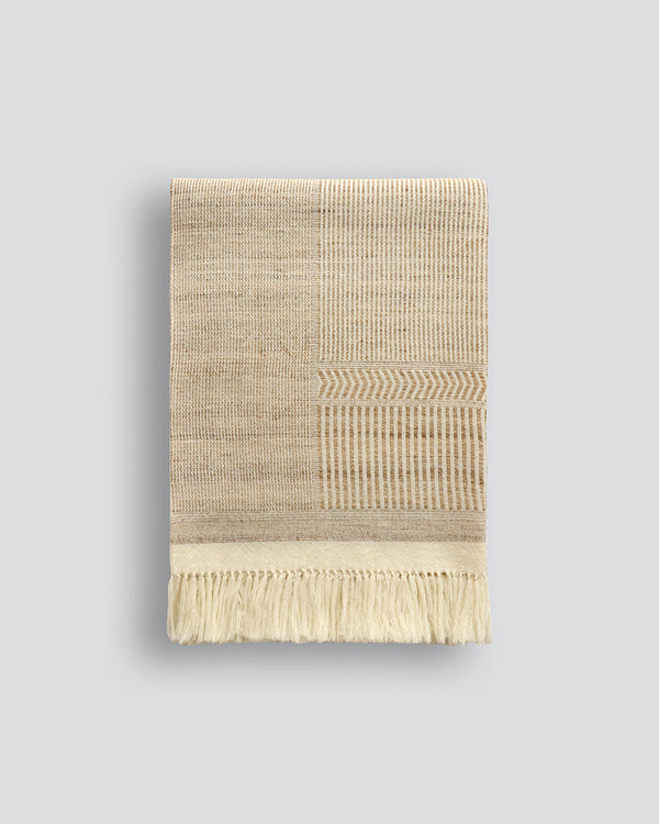 Navajo Throw Experience the beauty of handcrafted artisanal fabric. Celebrating the handmade, Navajo features an intricate, irregular design in natural shades of ecru and straw. Handwoven from a blend of wild tussah silk and wool, the textural fibres and