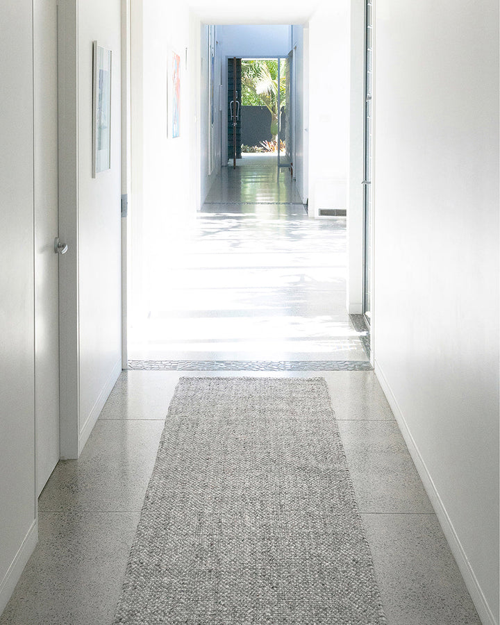 Nebraska Floor Runner Create a contemporary feel in any entrance or passageway with this simple wool-blend runner in a soft ash tone. This piece brings warmth and interest to transition spaces with its subtle mottled tone and versatile flatweave structure
