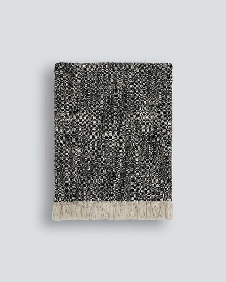 Perendale Throw Combining natural tones of ivory and charcoal, the dual-tone fibres of the Perendale creates an inviting, textural aesthetic. Handwoven from slubby strands of wool, the soft tones and medium-weight weave adds a sense of natural simplicity