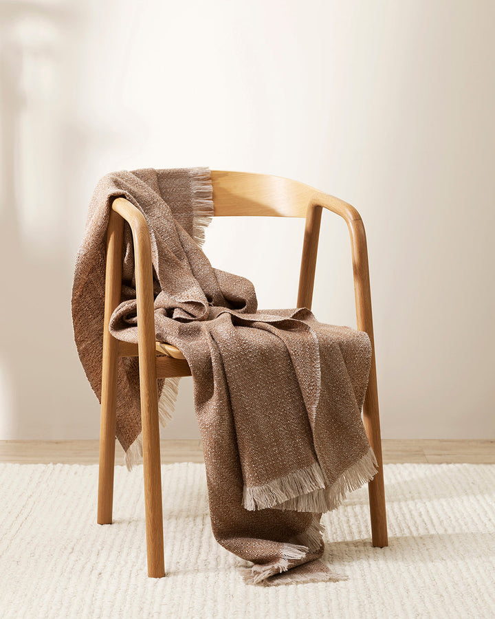 Perendale Throw Combining natural tones of ivory and charcoal, the dual-tone fibres of the Perendale creates an inviting, textural aesthetic. Handwoven from slubby strands of wool, the soft tones and medium-weight weave adds a sense of natural simplicity