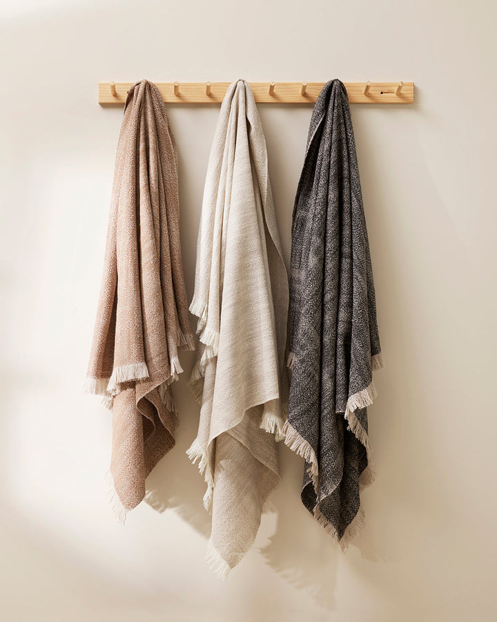 Perendale Throw Combining natural tones of ivory and charcoal, the dual-tone fibres of the Perendale creates an inviting, textural aesthetic. Handwoven from slubby strands of wool, the soft tones and medium-weight weave adds a sense of natural simplicity