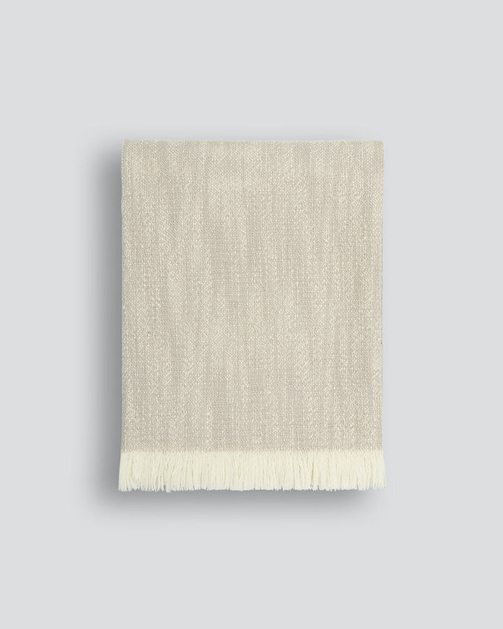 Perendale Throw Combining natural tones of ivory and charcoal, the dual-tone fibres of the Perendale creates an inviting, textural aesthetic. Handwoven from slubby strands of wool, the soft tones and medium-weight weave adds a sense of natural simplicity