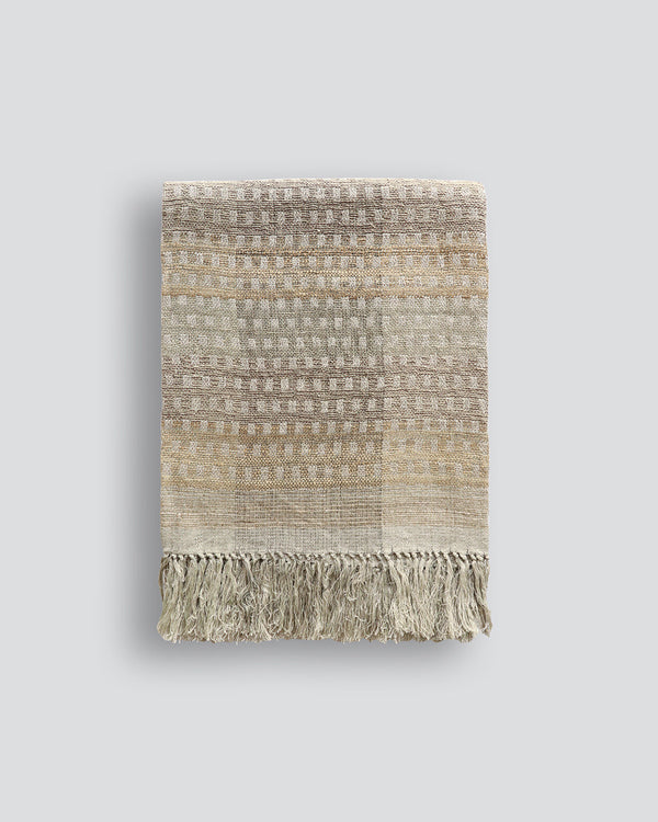 Solano Throw Celebrating the beauty of artisanal woven fabric, Solano is an exquisite textural piece in shades of muted sage, grey and putty. Handwoven in a silk-linen blend, the delicate surface pattern creates an inviting and serene aesthetic. Pair with