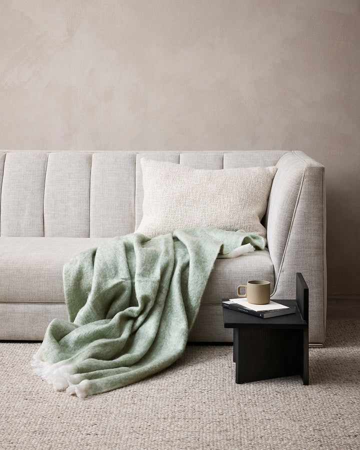 Sorrento Throw Enhance the warmth and comfort of your living space with the sumptuous addition of our Sorrento throw. Reminiscent of mohair, the brushed wool texture feels inviting and cocoon-like, while the earthy turmeric tone adds a touch of colour to