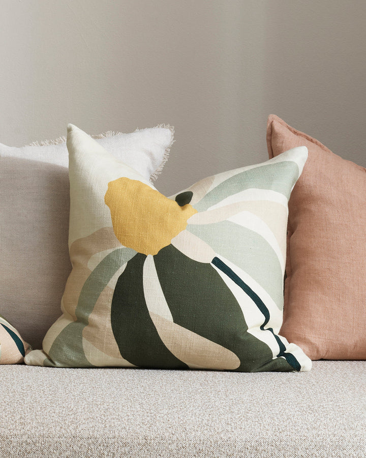 Verona Cushion A simplified daisy form is captured in a palette of sage, butter, biscuit, and bottle green in this uplifting cushion. Screen-printed onto a dense cotton base, Veronaâ€™s playful, free-spirited design feels fresh and summery when styled wit