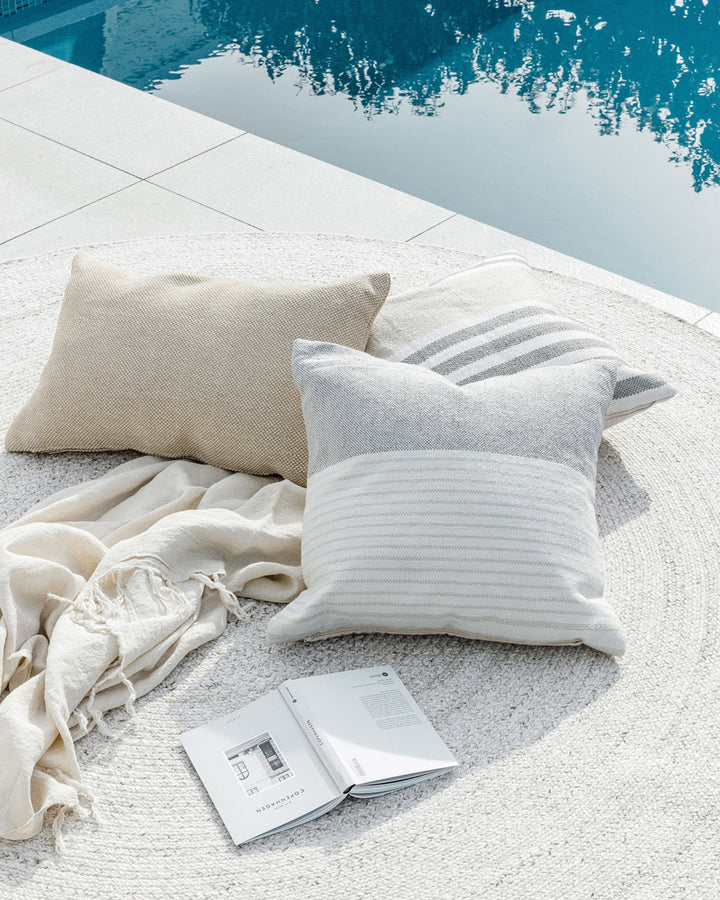 Willett Cushion Elevate your outdoors with the soft grey and white colourway of our Willett cushion. Handwoven from 100% PET yarn (a soft and supple fibre produced by recycling plastic bottles), the Willet pairs effortlessly with Corbett to create a conte