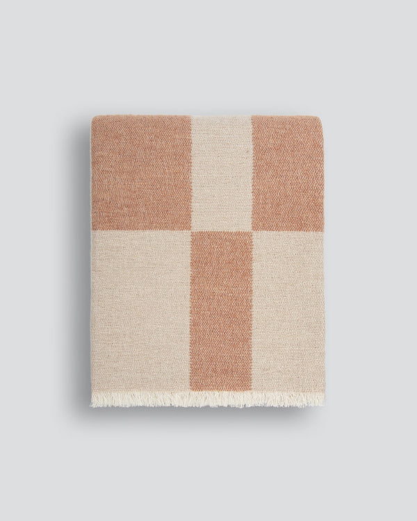 Winton Throw by Baya Add a cosy accent to your space with the playful design of the Winton. Crafted in a double-weave abstract check design, muted coral and ivory tones create the perfect blend of comfort and style. Expertly designed to add a touch of war